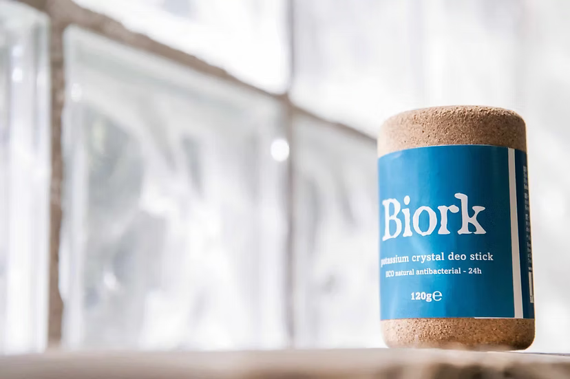 Biork deodorant stick with blue label and cork cap on a blurred background
