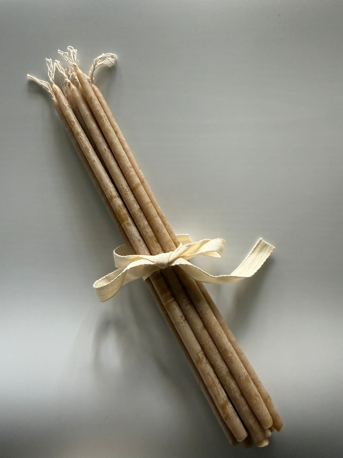 Mini beeswax candles made from pure beeswax with a soft golden glow and subtle honey scent