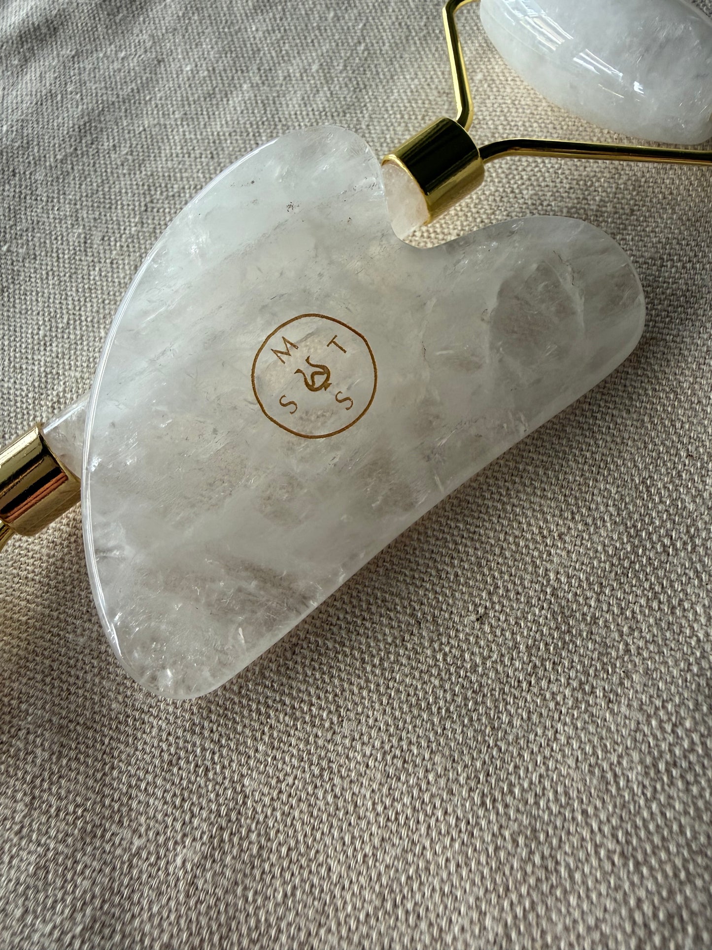 Clear quartz face roller and gua sha set for puffiness reduction and refreshed skin appearance