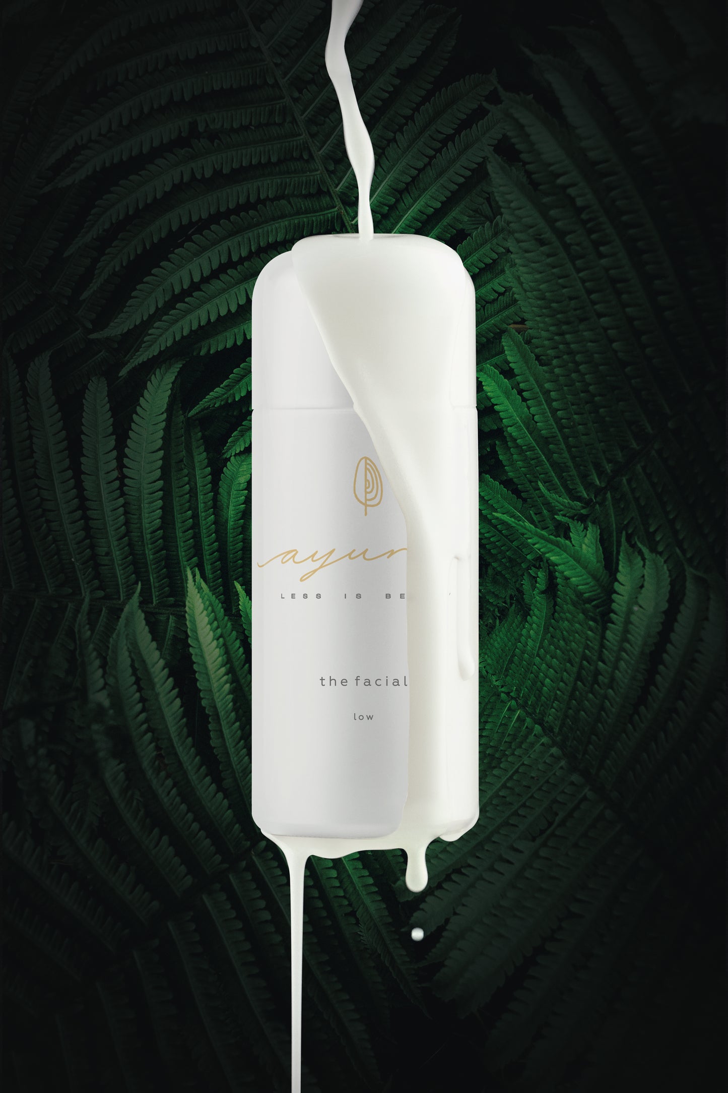 White bottle of ayuna the facial - low with green leafy background