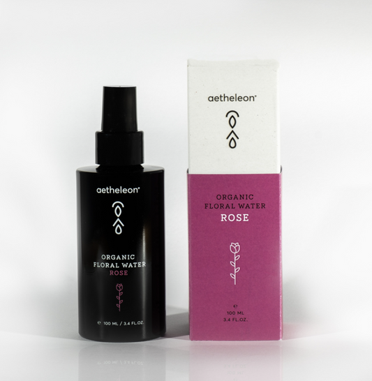 Glass bottle of rose water facial mist by Aetheleon, hydrating toner for radiant skin.