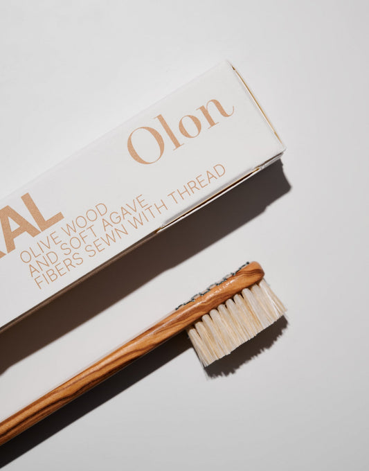 Olive wood toothbrush polished to be smooth. Agave fibers sewn with natural thread. Zero plastic. Designed by a periodontist. Natural oral hygiene.