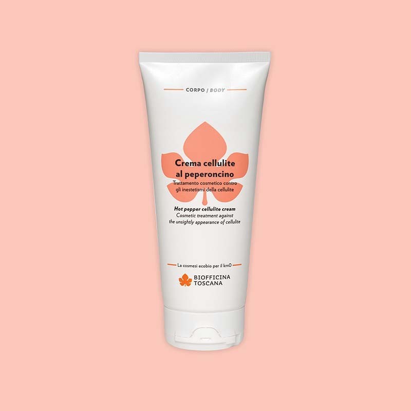 Tube of Biofficina Toscana Hot Pepper Cellulite Cream, a cosmetic treatment against the appearance of cellulite, displayed on a light peach background.