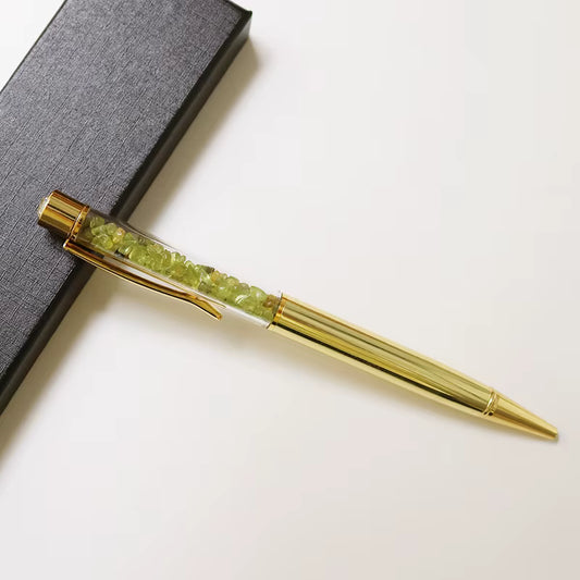 natural peridot crystal pen for journaling on prosperity and growth