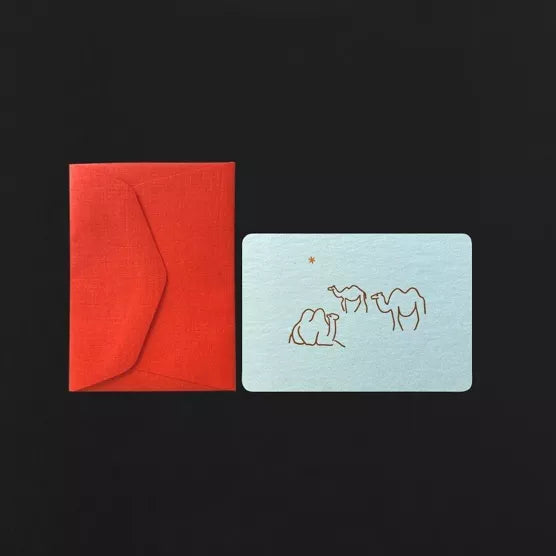 Red envelope and light blue card with camel illustrations on a black background