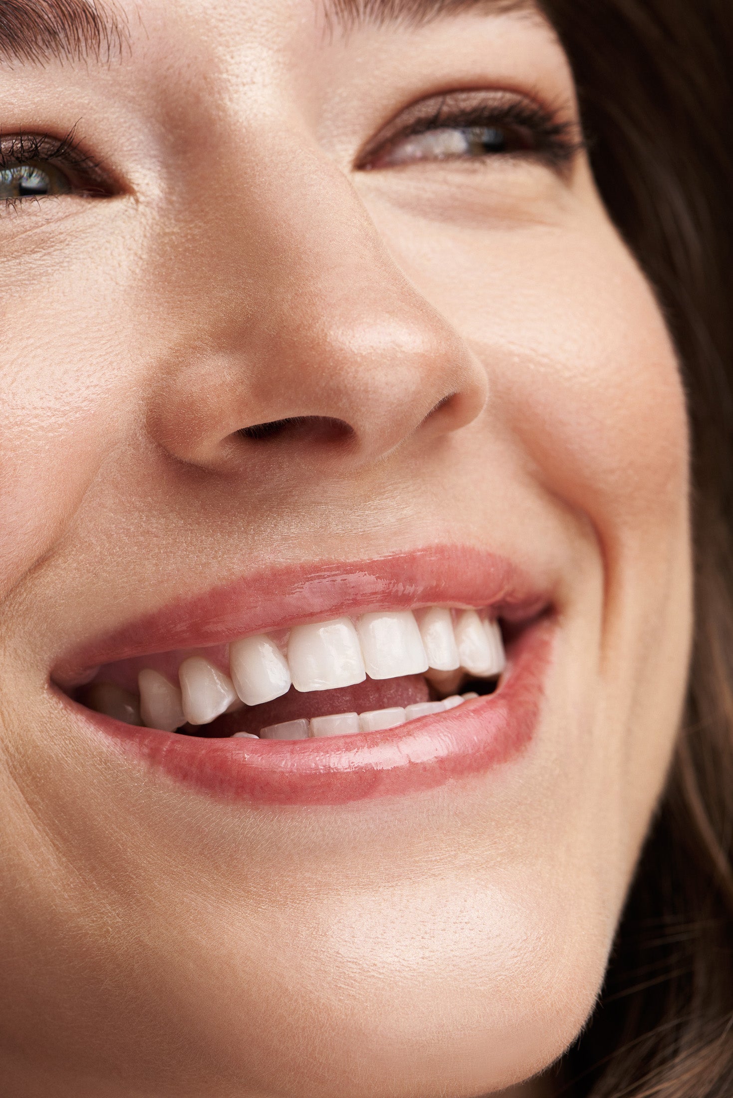close up on a womans teeth while she is smilling after using the Gentle Toothpaste by OLON