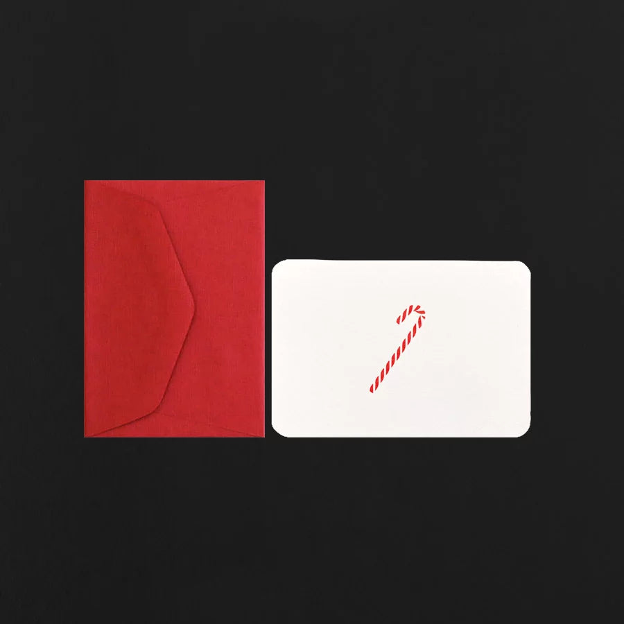 White card with a candy cane design and red envelope on a black background