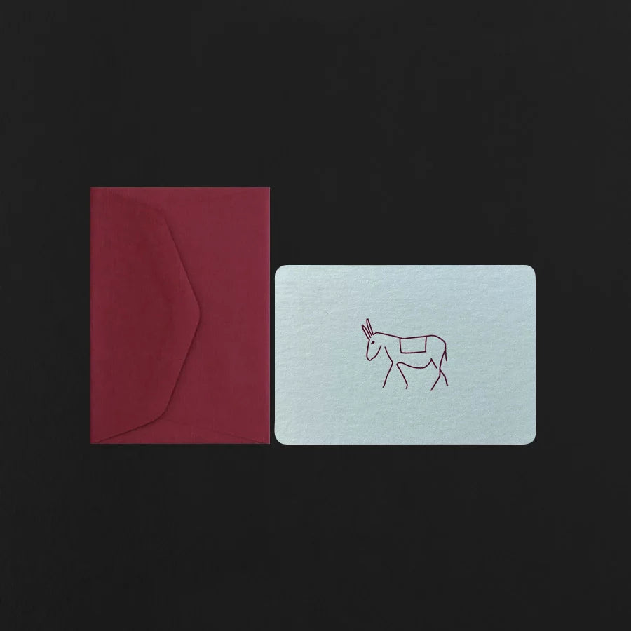 Red envelope and light blue card with a donkey illustration on a black background