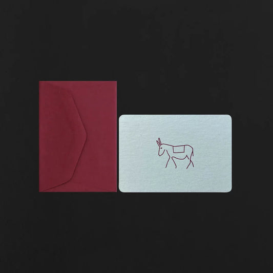 Red envelope and light blue card with a donkey illustration on a black background