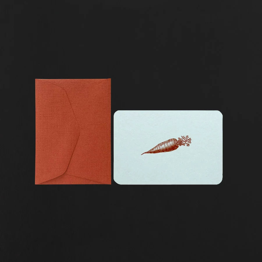 light blue card with a carrot design and red envelope on a black background