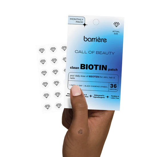 Barriere biotin patch packaging with patches with the black diamond symbol  held by a hand on a white background