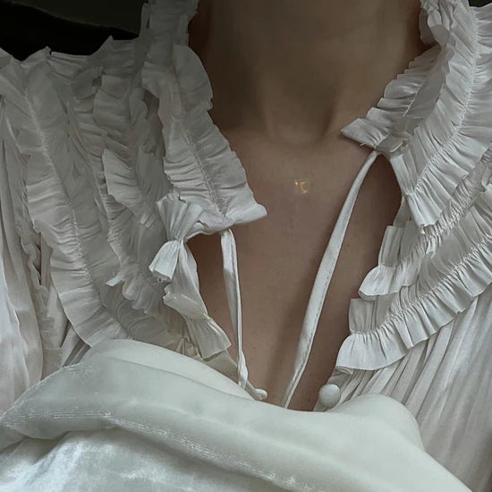 Close-up of a person wearing the Barriere melatonin patches with gold moon symbols 