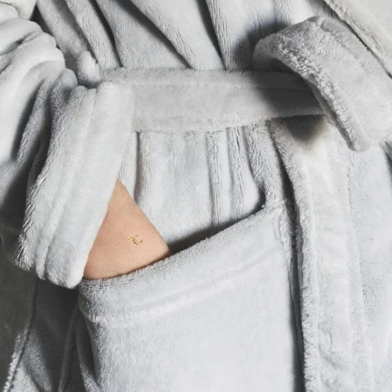 Close-up of a person wearing the Barriere melatonin patches with gold moon symbols 