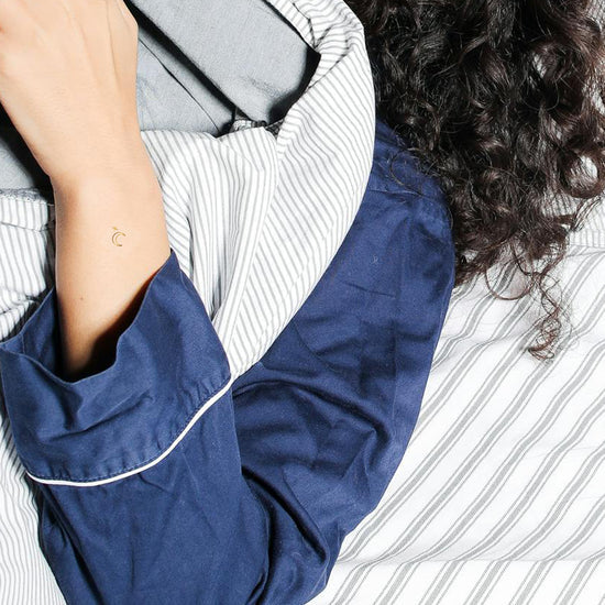 A person wearing the Barriere melatonin patches with gold moon symbols 