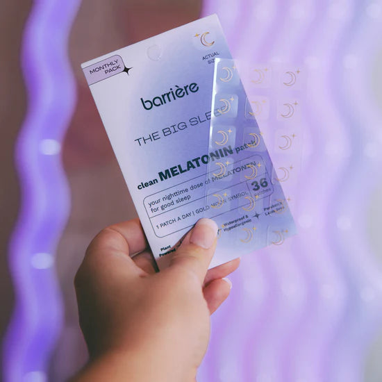 Hand holding a package of Barriere Melatonin patches with a purple gradient background