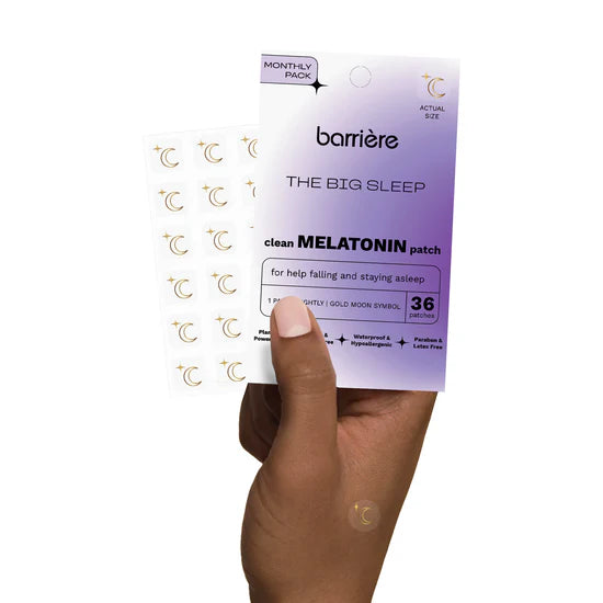 Barriere melatonin patches packaging with gold moon symbols  held by a hand on a white background
