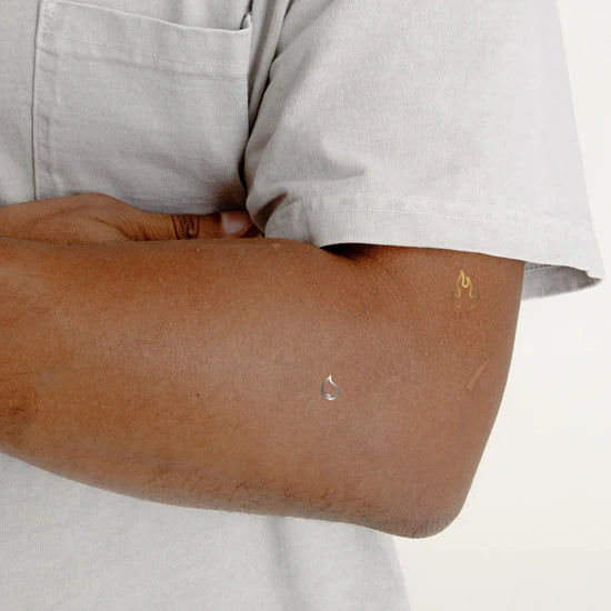 Close-up of a person wearing the Barriere Youth Repair clean NAD+ patch with metallic elements symbols