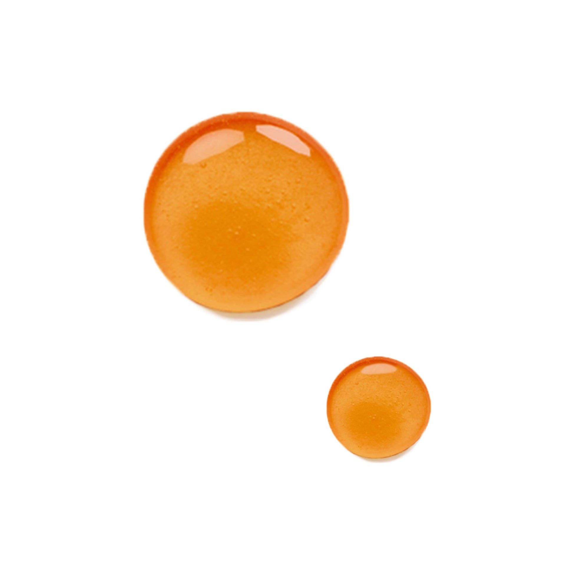 Close up of two drops of the Odacite Bu + L Firming serum on a white background