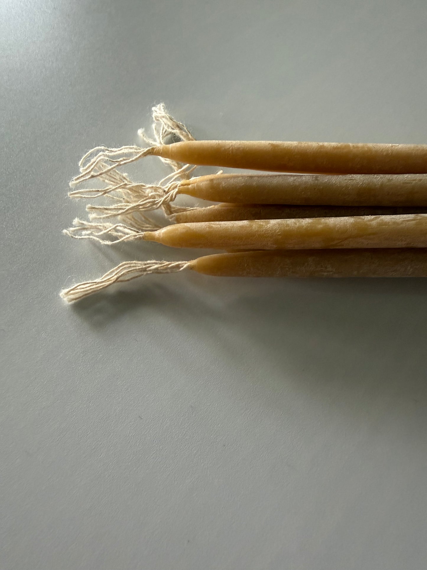     Natural beeswax taper candles handcrafted in small batches for warm ambient light