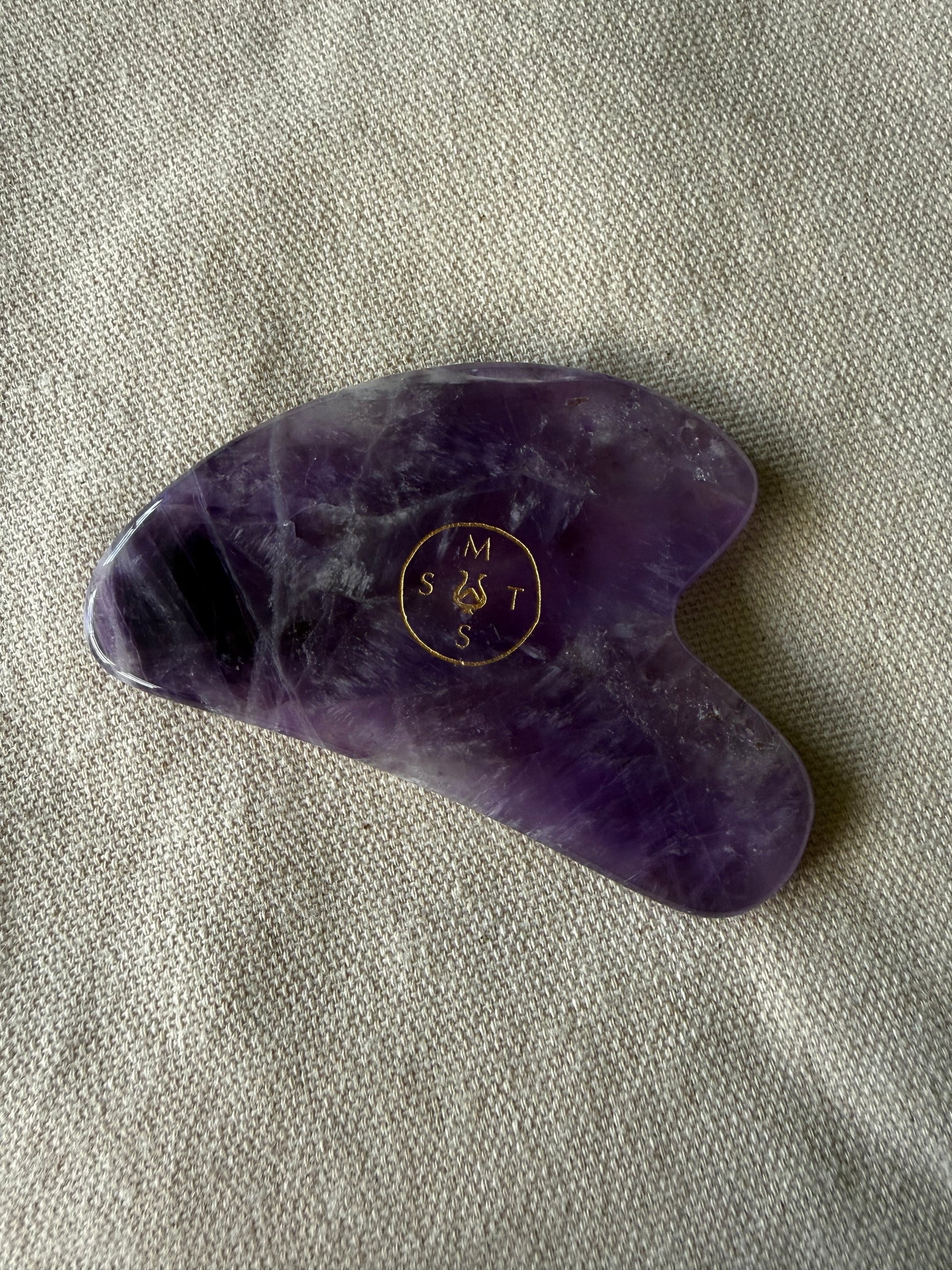     Hand-carved amethyst gua sha tool made from natural high-grade stone for facial massage and sculpting