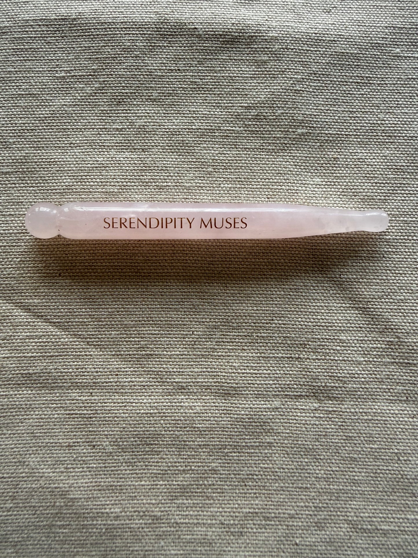     Dual-ended rose quartz facial tool designed for acupressure and circulation support