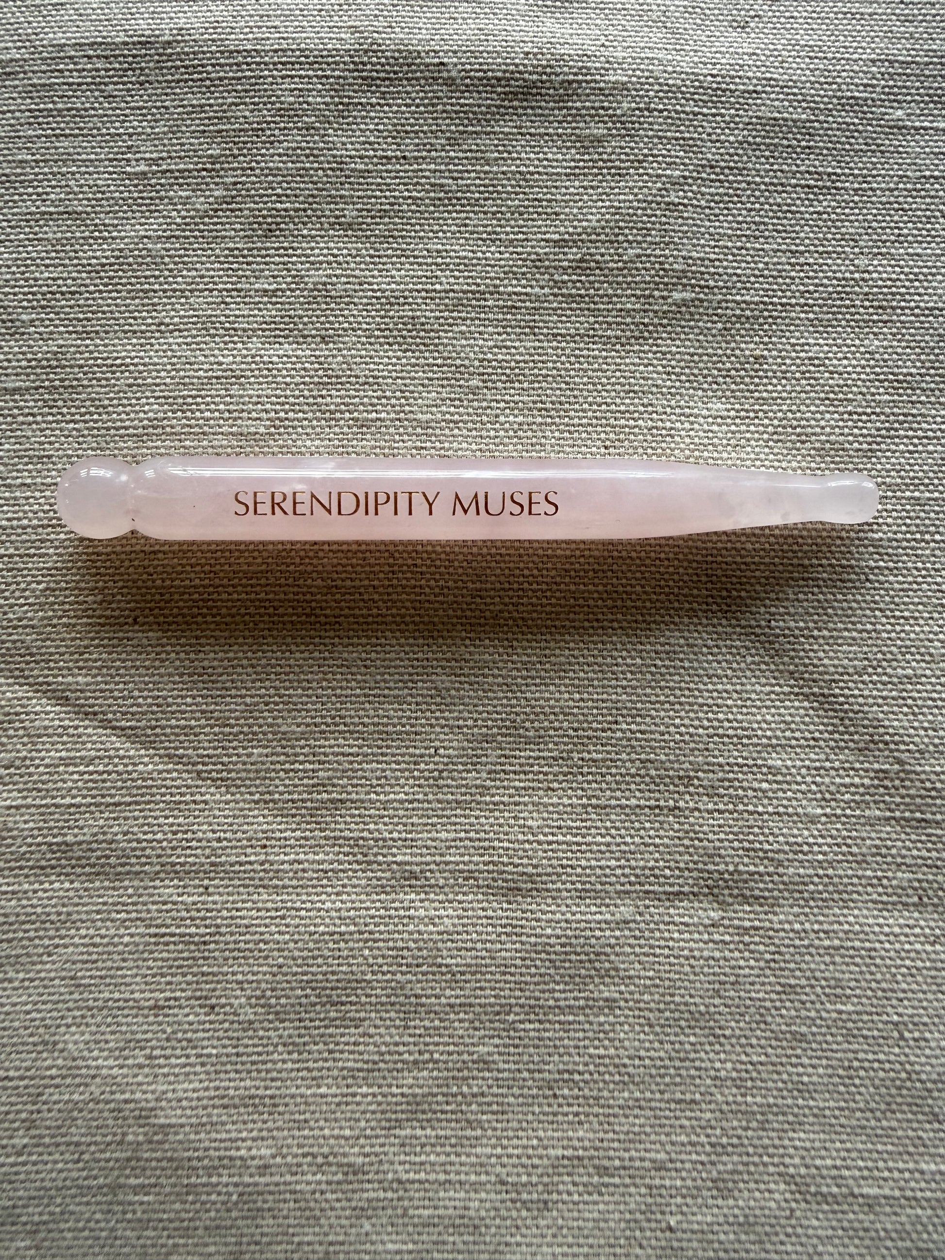     Dual-ended rose quartz facial tool designed for acupressure and circulation support