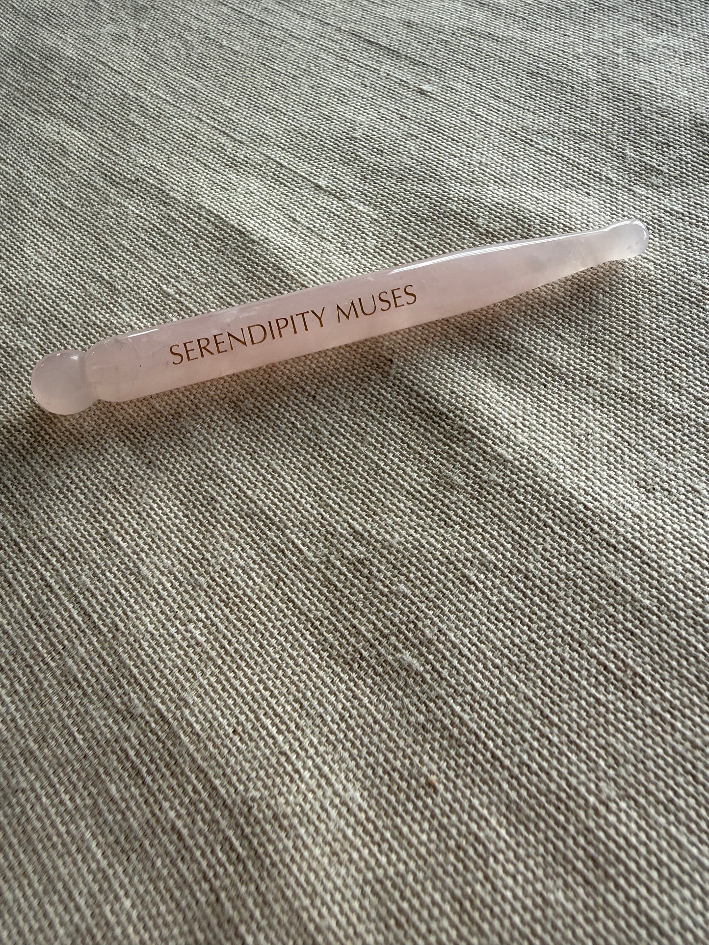     Smooth polished rose quartz acupressure pen for face, neck, and jaw massage