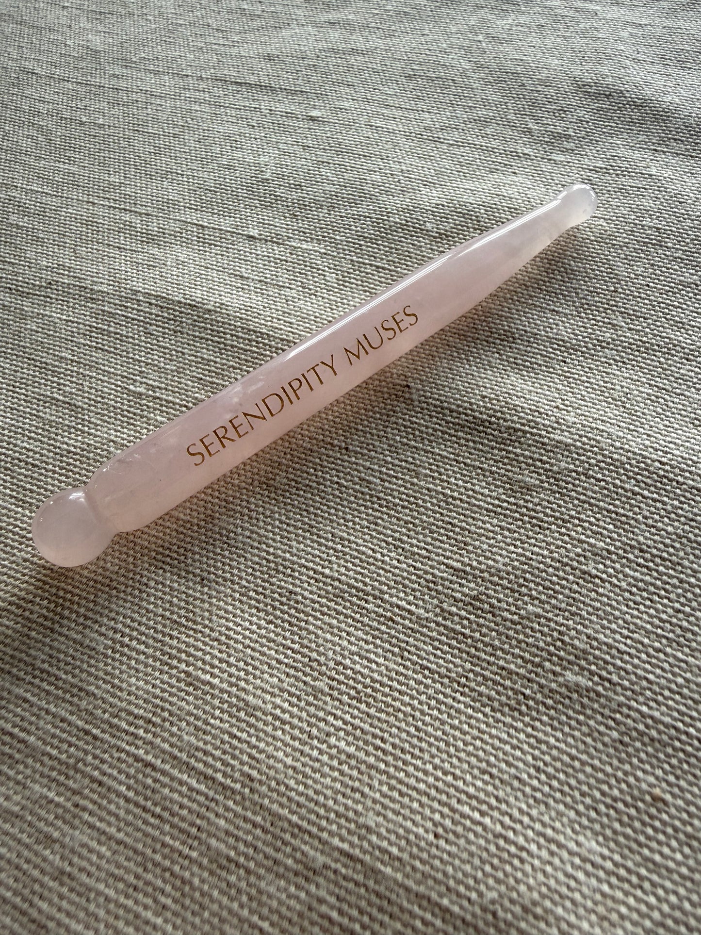     Rose quartz facial massage tool used for sculpting, depuffing, and fascia release