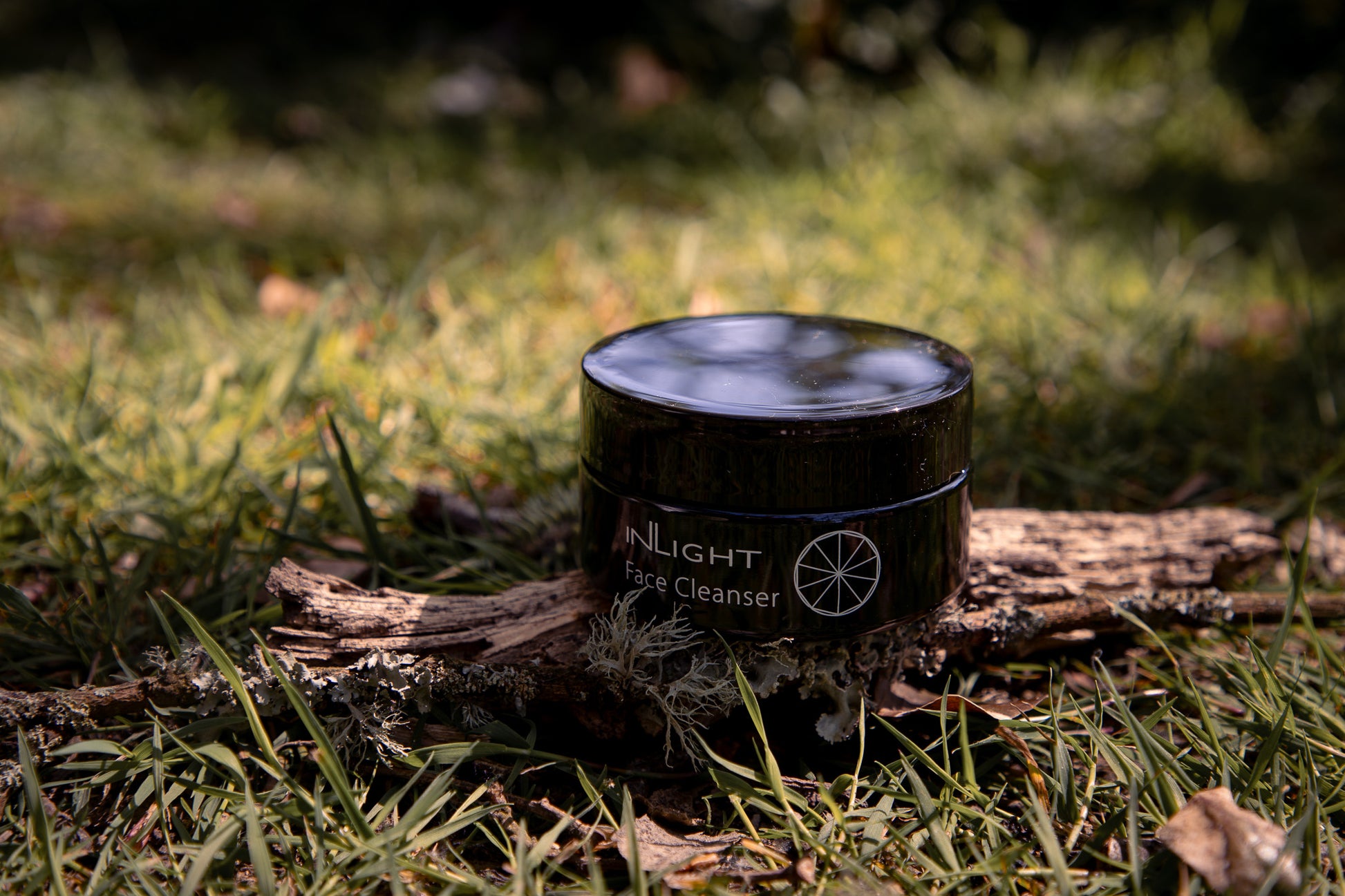  a jar of Inlight Face Cleanser in nature
