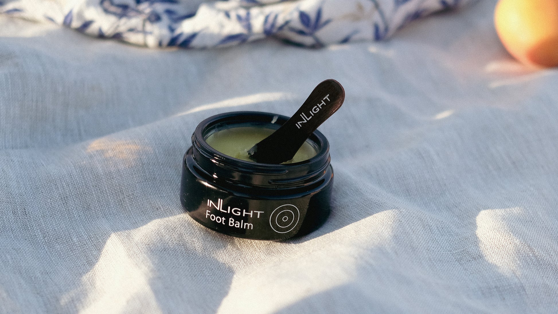 An open jar of Inlight Foot Balm 