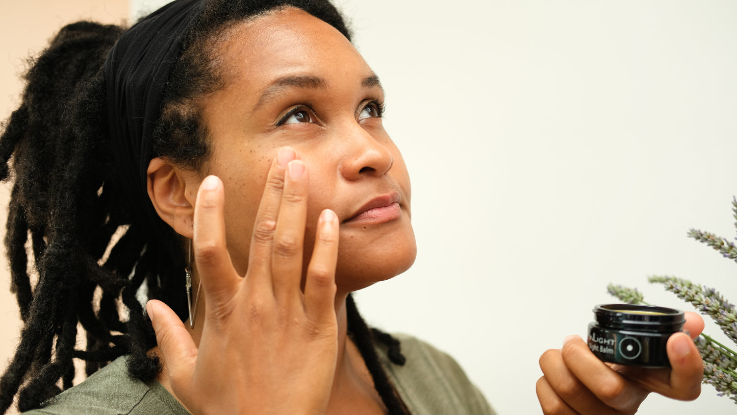 A person putting on the inLight Night Balm 