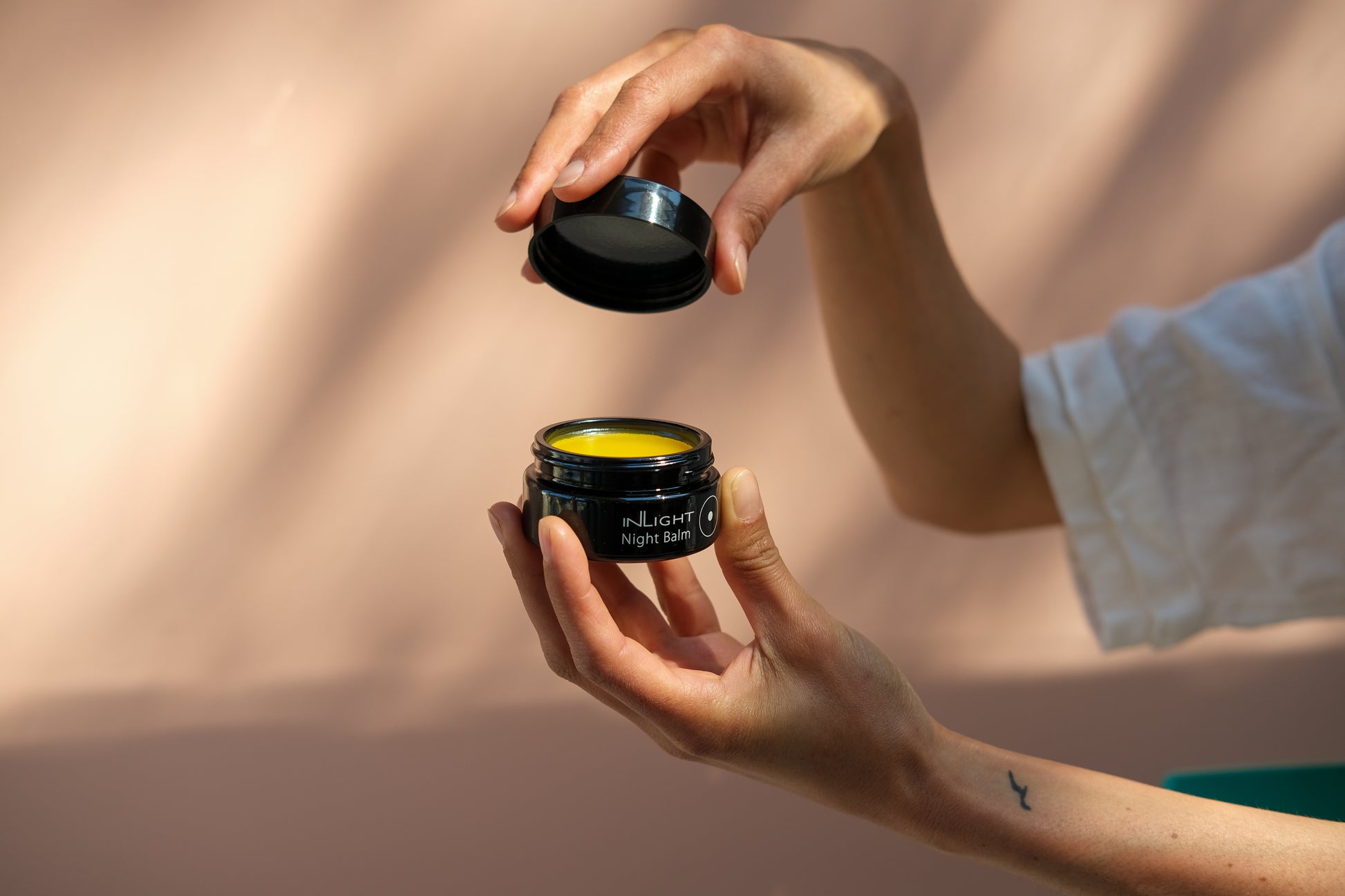 A person holding the inLight Night Balm 