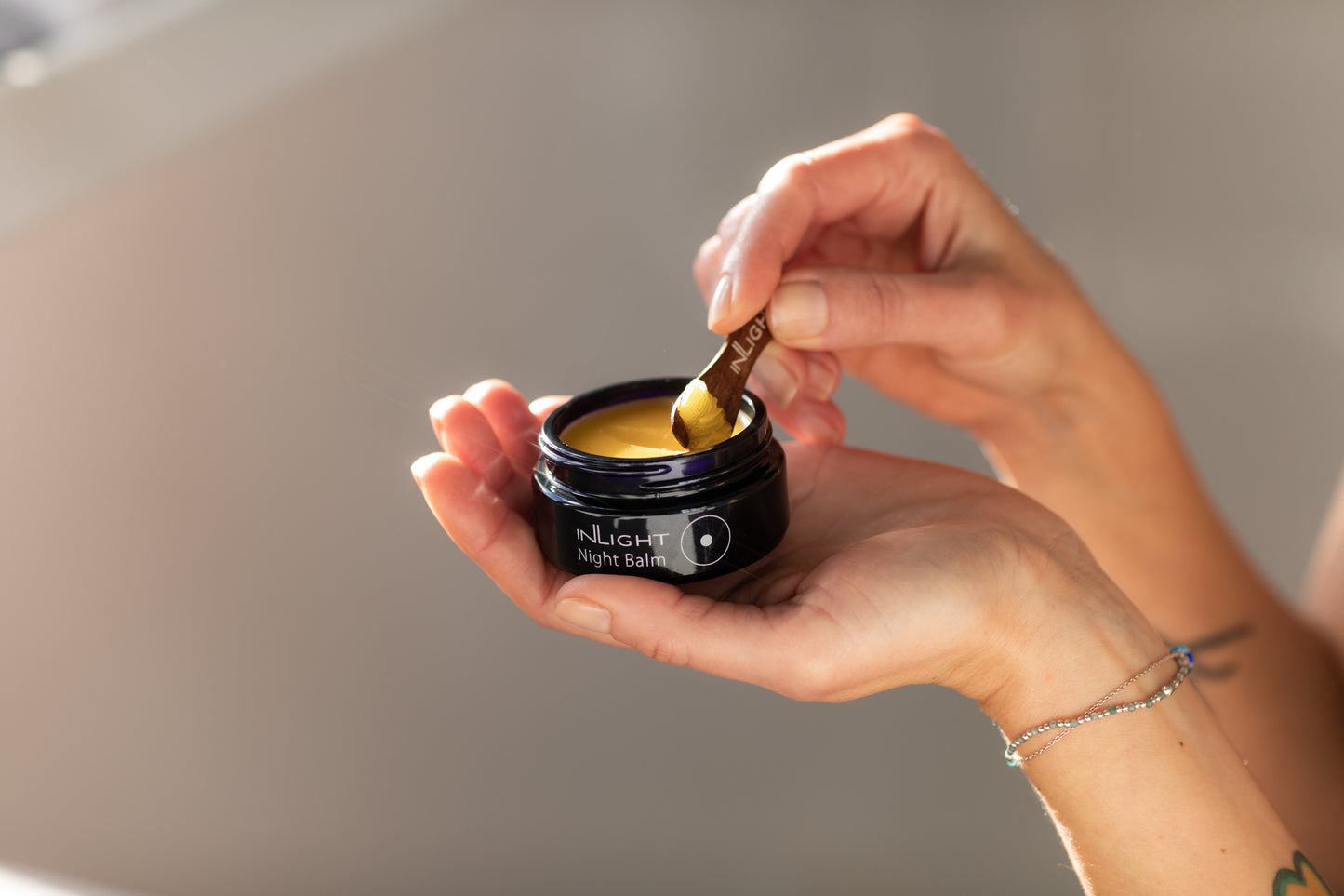 A person holding the inLight Night Balm 