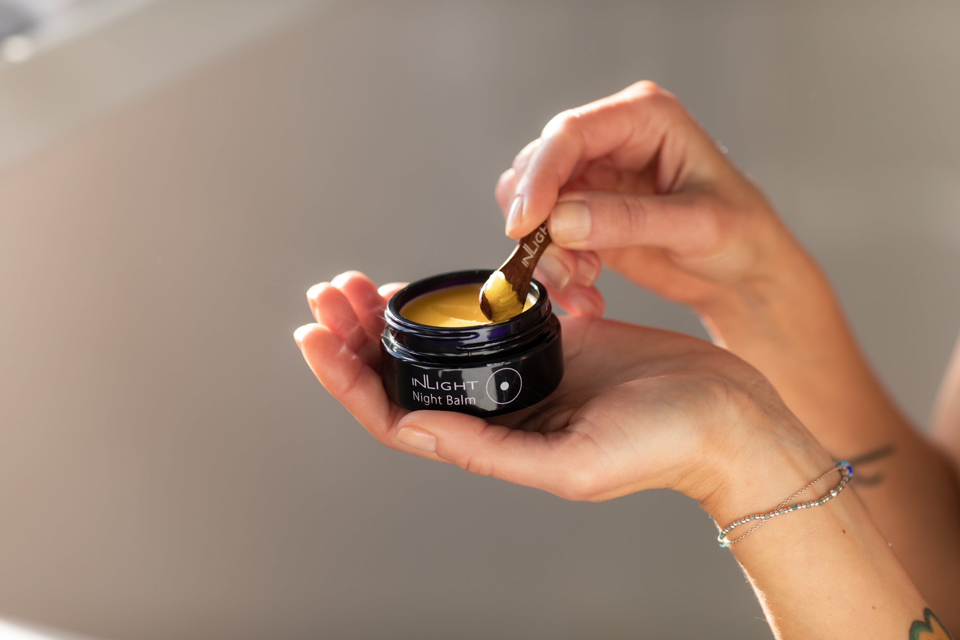 A person holding the inLight Night Balm 