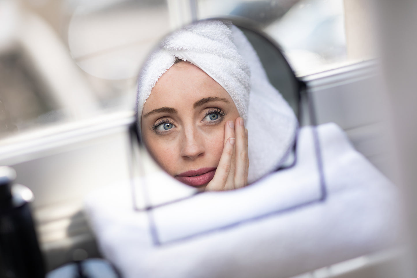 A woman putting on the Inlight Line Softener Intensive