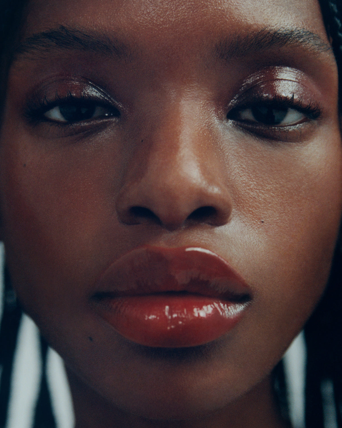 Close-up portrait of a woman wearing the Manasi 7 tinted beauty potion in the shade kagero against a light gray background.