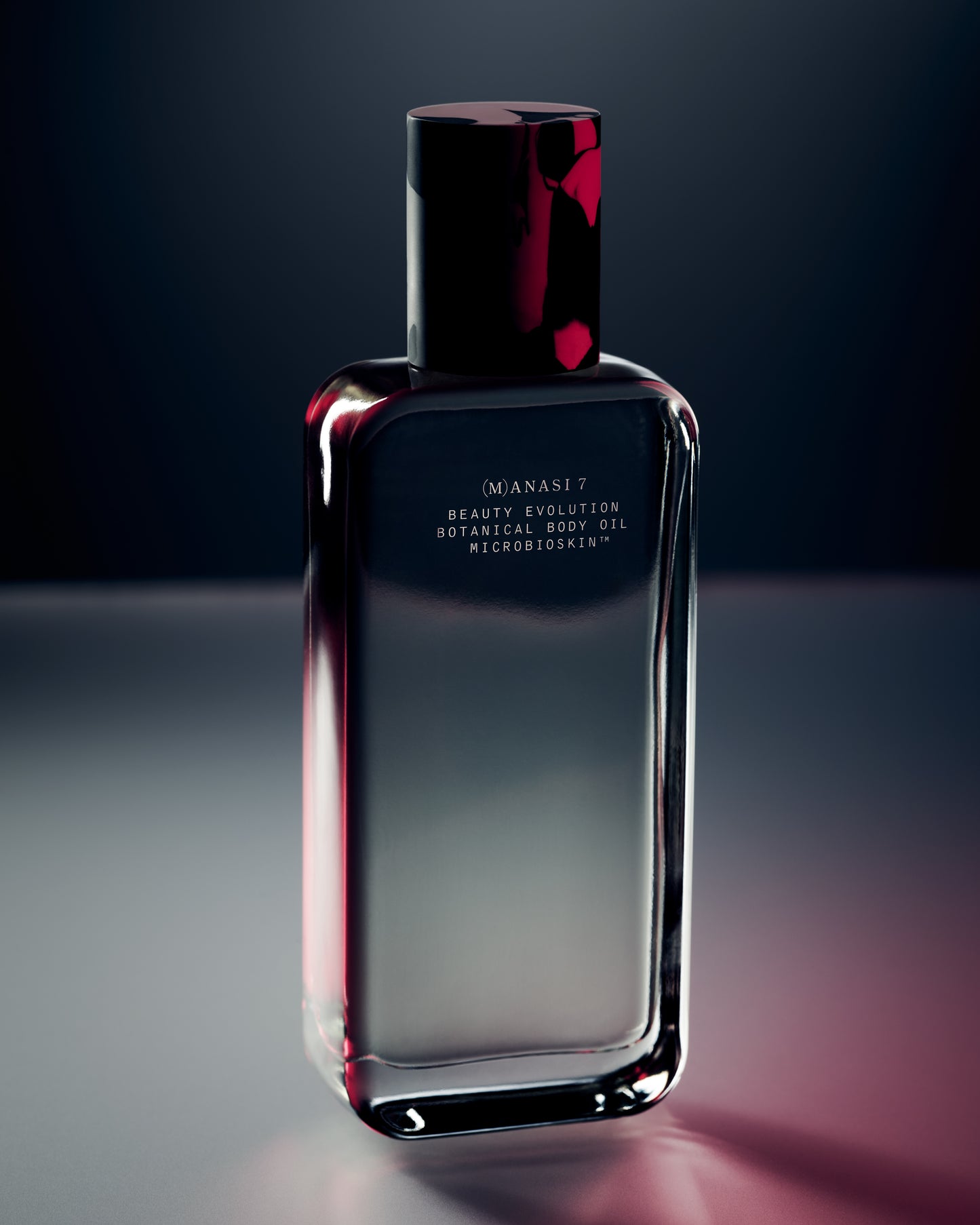 Glass bottle of the Manasi 7 Botanical Body Oil with red light