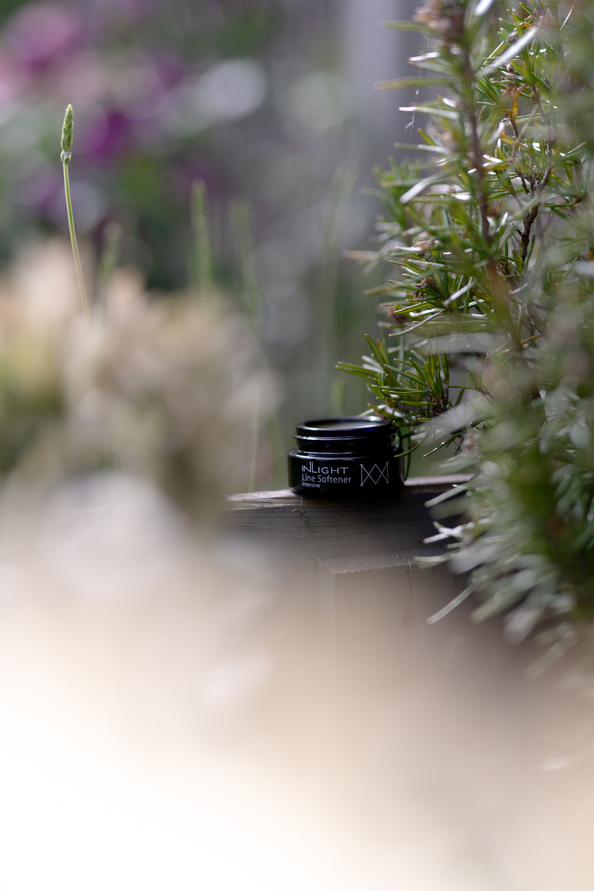 A jar of the Inlight Line Softener Intensive next to some plants