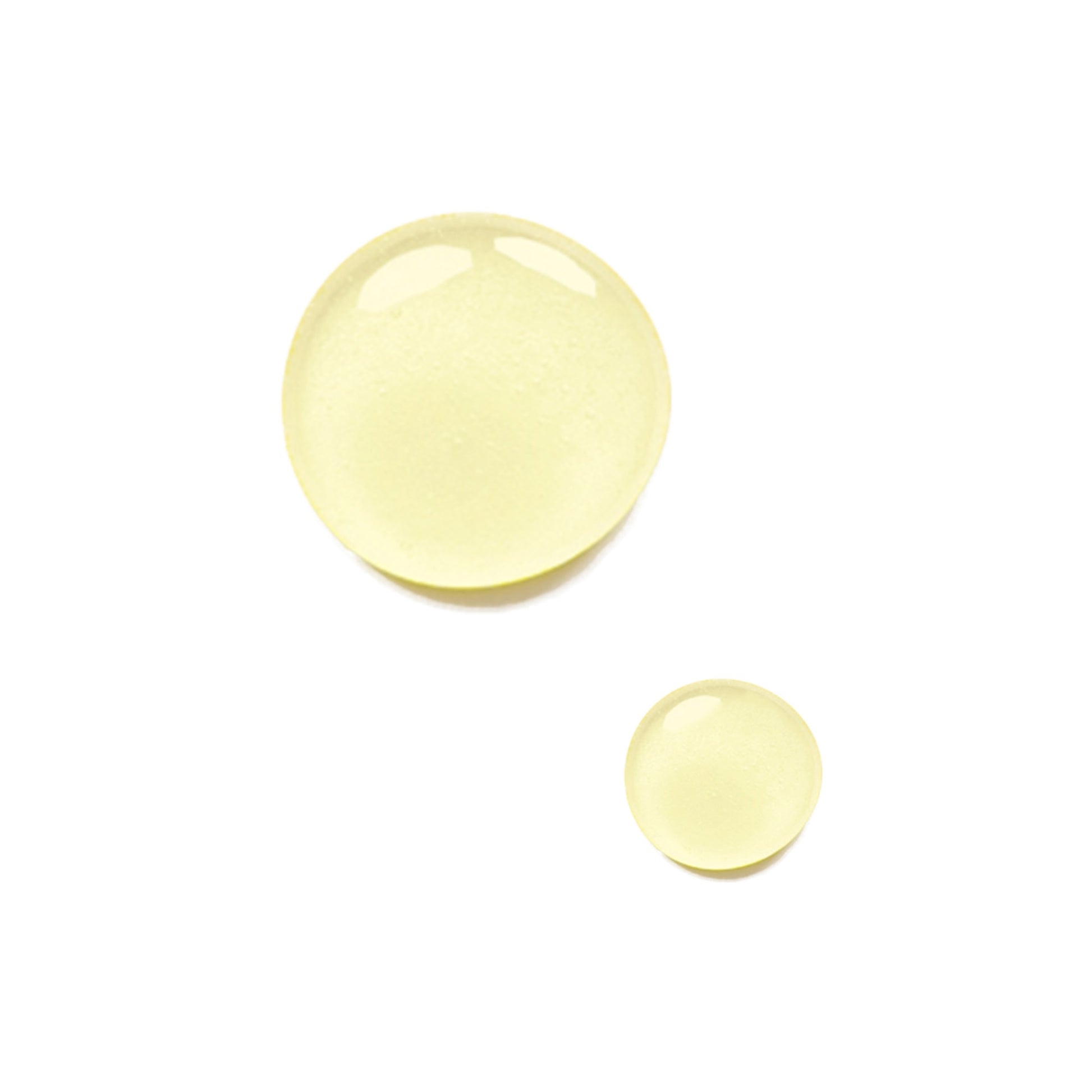 Close up of two drops of the Odacite dark spots serum concentrate on a white background