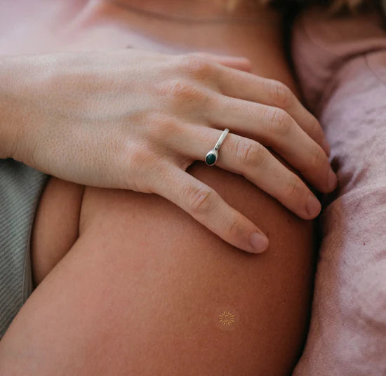 Close-up of a person wearing the Barriere vitamin D3 patch packaging with sun symbol design on their arm