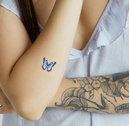 A person wearing the barriere Brains & Beauty Patch with butterfly designs