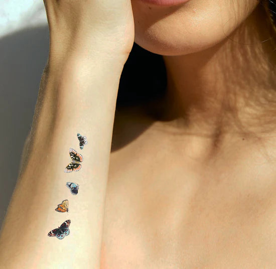 A person wearing the barriere Brains & Beauty Patch with butterfly designs