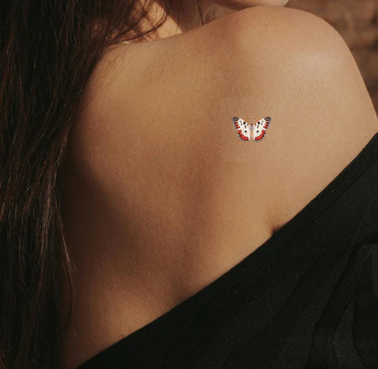 A person wearing the barriere Brains & Beauty Patch with butterfly designs