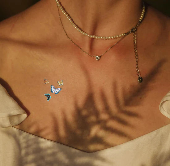 A person wearing the barriere Brains & Beauty Patch with butterfly designs