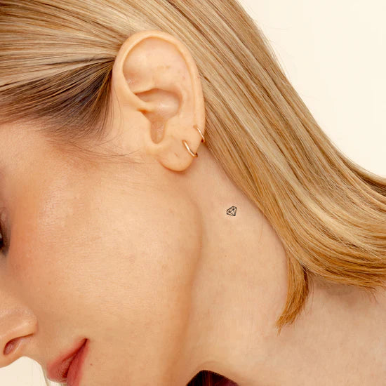 Close-up of a person wearing the Barriere biotin patch with the black diamond symbol on their neck