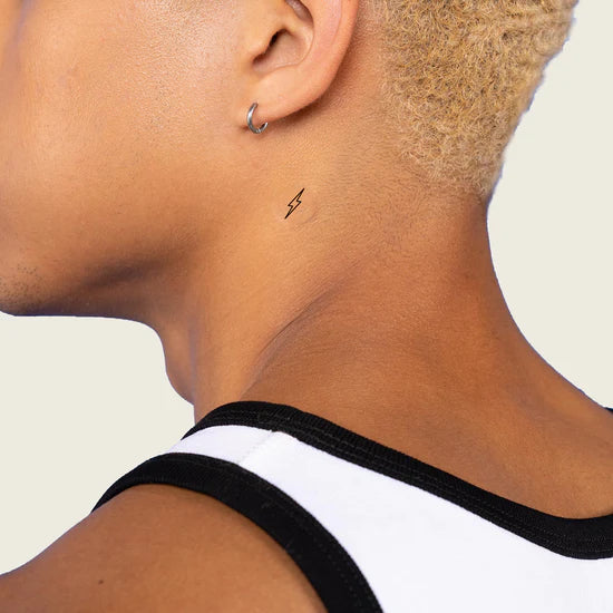 Close-up of a person wearing the Barriere Energy Boost vitamin B12 patch with the black bolt symbol on their neck