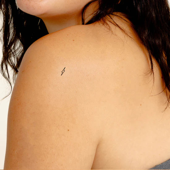 Close-up of a person wearing the Barriere Energy Boost vitamin B12 patch with the black bolt symbol on their shoulder