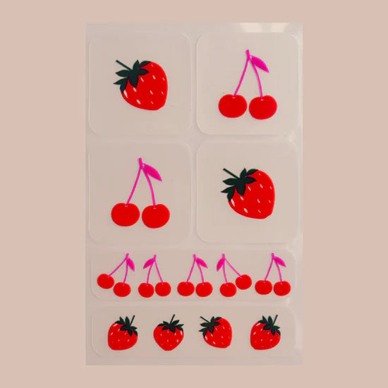 Sheet of Barriere skin support patch packaging with fruit designs on a clear background