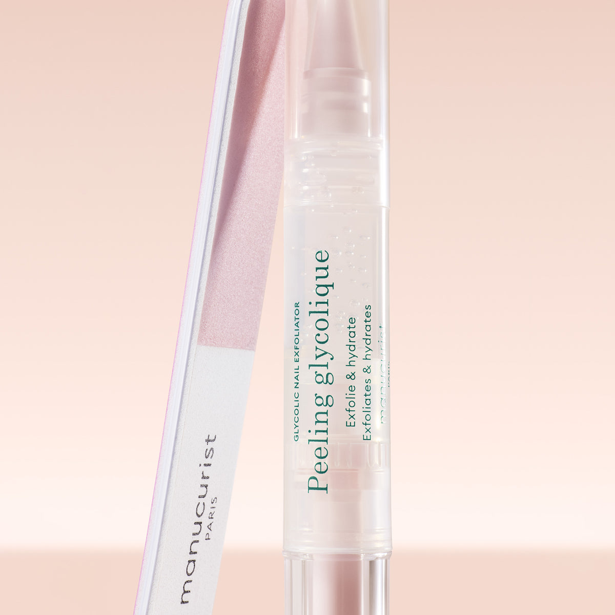 Manucurist Peeling Glycolique bottle on a light pink background