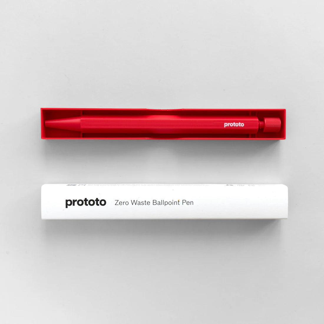 Red ballpoint pen in a red holder with 'prototo' branding and white packaging on a white background